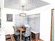 Eat-in kitchen and dining area with decorative ceiling, bench seating, and modern light fixture at 7770 W 87Th Dr # F, Arvada, CO 80005