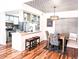 Open kitchen featuring stainless steel appliances, quartz countertops, and stylish bar stool seating at 7770 W 87Th Dr # F, Arvada, CO 80005