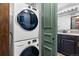 Modern, stacked Samsung washer and dryer next to a stylish bathroom door at 7770 W 87Th Dr # F, Arvada, CO 80005