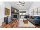 Bright living room with stone fireplace, hardwood floors, and sliding glass door to balcony at 7770 W 87Th Dr # F, Arvada, CO 80005