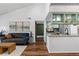 Spacious living room with hardwood floors seamlessly flows to the open-concept kitchen, perfect for entertaining at 7770 W 87Th Dr # F, Arvada, CO 80005