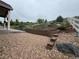 Backyard landscaping with a rock wall, stone steps, and a white fence at 3855 Old Oaks St, Castle Rock, CO 80104