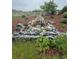 Backyard view of a rock waterfall with various plants and mulch landscaping at 3855 Old Oaks St, Castle Rock, CO 80104