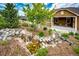 Landscaped backyard with a rock garden, waterfall feature, and a cozy patio with outdoor seating at 3855 Old Oaks St, Castle Rock, CO 80104