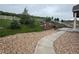 Beautifully landscaped backyard featuring terraced gardens, a white fence, and decorative stone accents at 3855 Old Oaks St, Castle Rock, CO 80104