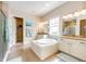 Bathroom suite featuring a soaking tub, dual vanities, and a separate shower at 3855 Old Oaks St, Castle Rock, CO 80104