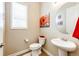 Cozy bathroom features a pedestal sink, tile floors, and a standard toilet at 3855 Old Oaks St, Castle Rock, CO 80104