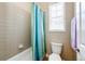 Bathroom featuring a shower-tub combo with decorative shower curtain and a standard toilet at 3855 Old Oaks St, Castle Rock, CO 80104