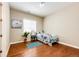Cozy bedroom with hardwood floors, a single bed with floral bedding, and a large window at 3855 Old Oaks St, Castle Rock, CO 80104