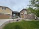 Inviting two-story home with stone accents, a cozy front porch, and a well-kept lawn at 3855 Old Oaks St, Castle Rock, CO 80104
