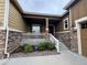 Charming front porch with stone detailing, white railings, and well-maintained landscaping at 3855 Old Oaks St, Castle Rock, CO 80104