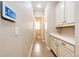 Hallway featuring built-in cabinets with granite countertops, tile floors, and access to the bathroom at 3855 Old Oaks St, Castle Rock, CO 80104
