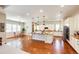 Spacious kitchen features hardwood floors, granite countertops, and large island with pendant lighting at 3855 Old Oaks St, Castle Rock, CO 80104