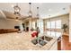 Kitchen island featuring granite countertops, pendant lighting, and stainless steel sink with view to the living room at 3855 Old Oaks St, Castle Rock, CO 80104