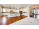 Bright, open kitchen with white cabinets, granite countertops, and modern appliances at 3855 Old Oaks St, Castle Rock, CO 80104