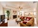 Spacious living room with a cozy fireplace, open layout, and seamless flow to the kitchen, perfect for entertaining at 3855 Old Oaks St, Castle Rock, CO 80104