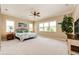 Large main bedroom with ceiling fan, plush carpeting, and plenty of natural light at 3855 Old Oaks St, Castle Rock, CO 80104