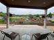 Serene view of a landscaped yard with a small waterfall feature, seen from a covered patio at 3855 Old Oaks St, Castle Rock, CO 80104