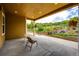 Covered patio with outdoor seating overlooking a beautifully landscaped yard with a charming rock garden at 3855 Old Oaks St, Castle Rock, CO 80104
