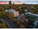 Aerial view of a neighborhood with diverse homes, mature trees, and city skyline at 408 E 1St Ave, Denver, CO 80203
