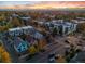 Stunning aerial view of a neighborhood showcasing varied architecture against a backdrop of mountains at sunset at 408 E 1St Ave, Denver, CO 80203