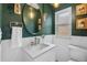 Elegant bathroom featuring a round mirror, unique lighting fixtures, and white subway tile at 408 E 1St Ave, Denver, CO 80203