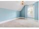 Bright bedroom featuring blue walls, a white window, and a unique ceiling fan at 408 E 1St Ave, Denver, CO 80203