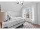 Serene bedroom with a large window, white bedding, and neutral carpet at 408 E 1St Ave, Denver, CO 80203