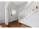Bright entryway showcasing a decorative front door, wooden floors, and staircase at 408 E 1St Ave, Denver, CO 80203