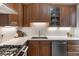 Well-appointed kitchen featuring stainless steel appliances and custom wood cabinets at 408 E 1St Ave, Denver, CO 80203