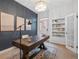 Home office with custom shelves, modern desk, and ample natural light at 408 E 1St Ave, Denver, CO 80203