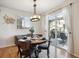 Bright dining room with wood table and chairs, access to backyard patio at 4841 S Picadilly Ct, Aurora, CO 80015