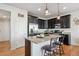 Modern kitchen with dark cabinets, granite countertops, and island at 4841 S Picadilly Ct, Aurora, CO 80015