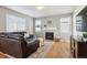 Living room with hardwood floors, fireplace, and large windows at 4841 S Picadilly Ct, Aurora, CO 80015