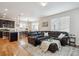 Open concept living room and kitchen with hardwood floors and a sectional sofa at 4841 S Picadilly Ct, Aurora, CO 80015