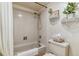 Cozy bathroom featuring a bathtub with shower, toilet, and decorative shelves at 4070 S Atchison Way # 203, Aurora, CO 80014