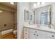 Bright bathroom featuring a bathtub with shower, toilet, and vanity with sink and mirror at 4070 S Atchison Way # 203, Aurora, CO 80014