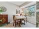 Charming dining area with a round table, wood chairs, and a large window providing natural light and neighborhood views at 4070 S Atchison Way # 203, Aurora, CO 80014