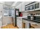 Bright kitchen with stainless steel appliances, wooden floors, and white cabinets and countertops at 4070 S Atchison Way # 203, Aurora, CO 80014