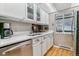 Bright kitchen with stainless steel appliances, wooden floors, and white cabinets and countertops at 4070 S Atchison Way # 203, Aurora, CO 80014