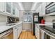 Bright kitchen with stainless steel appliances, wooden floors, and white cabinets and countertops at 4070 S Atchison Way # 203, Aurora, CO 80014