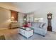 Comfortable living room with neutral paint, plush sofa, and ample natural light from the sliding glass door at 4070 S Atchison Way # 203, Aurora, CO 80014