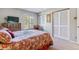 Cozy main bedroom with a floral-patterned bed, TV, side tables, and a window for ample natural light at 4070 S Atchison Way # 203, Aurora, CO 80014