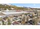 An aerial view showcasing homes near a snowy field, mountains, and town buildings at 57 Audrey Cir, Breckenridge, CO 80424