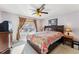 Bedroom featuring a ceiling fan, bedside tables, and a large window at 57 Audrey Cir, Breckenridge, CO 80424