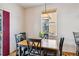Cozy dining area featuring a wood table with black chairs, lit by natural light from a window at 57 Audrey Cir, Breckenridge, CO 80424