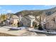 Attractive gray two-story home with red trim in a peaceful neighborhood, with mature trees and winter charm at 57 Audrey Cir, Breckenridge, CO 80424