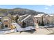 Lovely two-story home with a gray exterior and red trim, set against a backdrop of snow-covered mountains at 57 Audrey Cir, Breckenridge, CO 80424