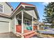 Charming gray home with a red-railed front porch and two bright blue Adirondack chairs at 57 Audrey Cir, Breckenridge, CO 80424