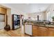 Bright kitchen with granite countertops, wood cabinets, and an adjacent dining area with winter view at 57 Audrey Cir, Breckenridge, CO 80424
